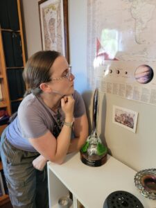 A photo Marie Brennan with the Hugo trophy for speculative poetry, awarded at Worldcon 2025